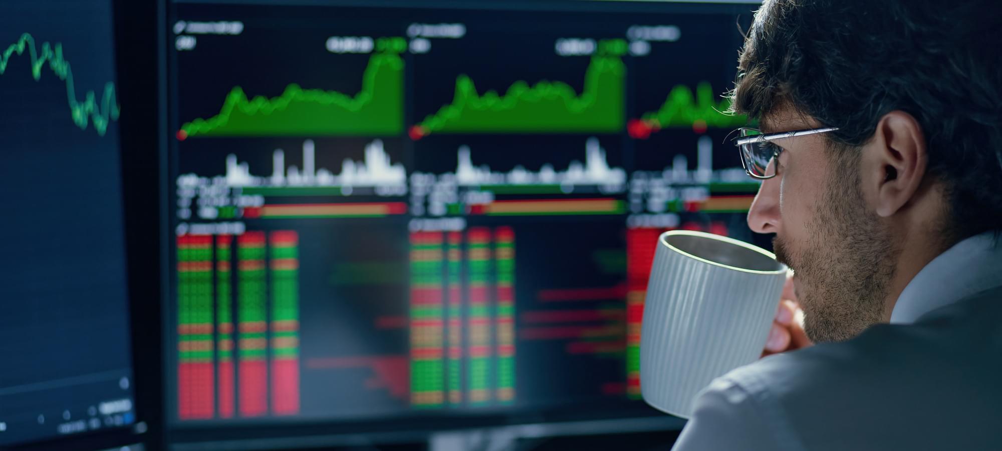 A sports betting investor analyzing data and drinking coffee